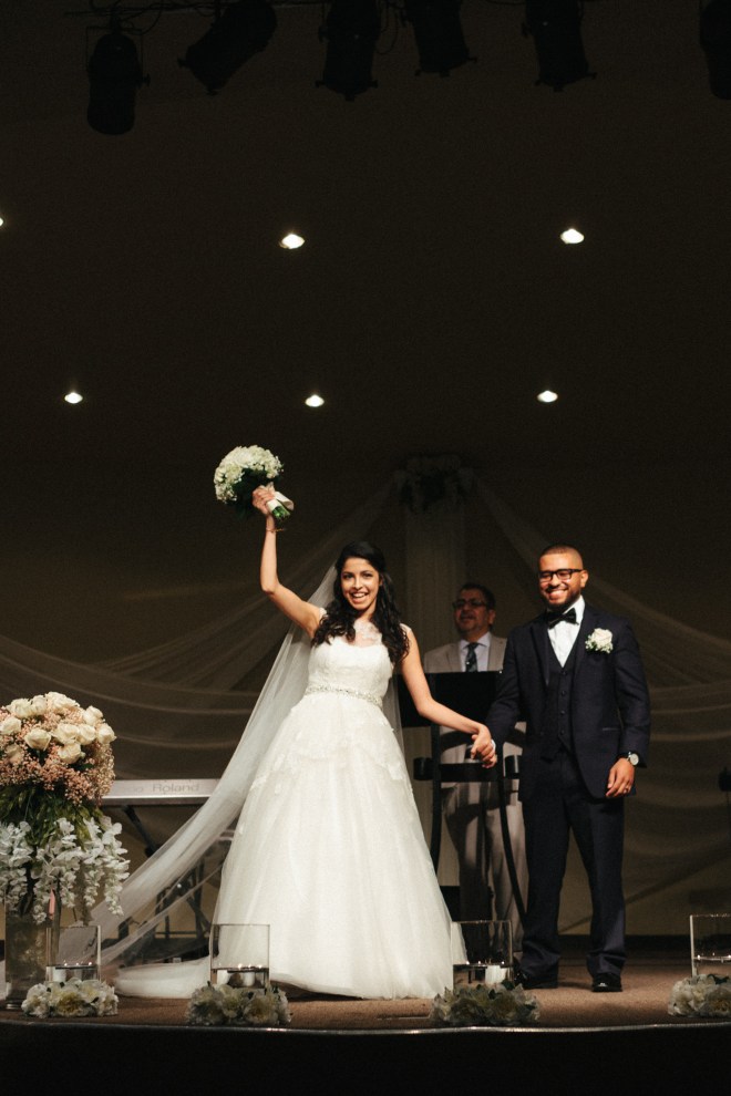 bride and groom cheer after they are pronounced